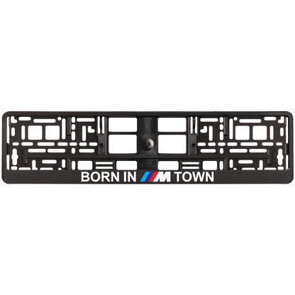 Black license plate frame with 'Born in M Town' text