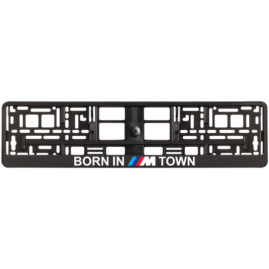 Black license plate frame with 'Born in M Town' text